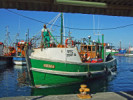 Fisherman on his boat in Kalk Bay Harbour Fisherman on his boat in Kalk Bay Harbour